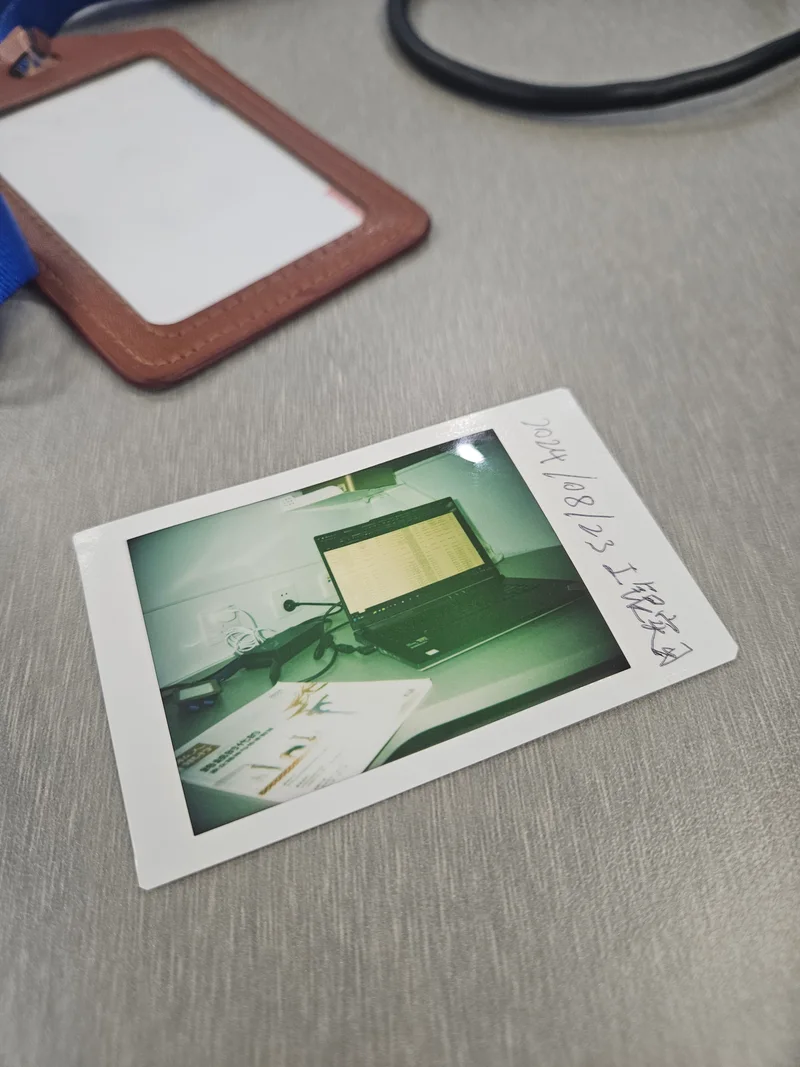 An instant photograph and lanyard from the ICBC internship, dated August 23, 2024