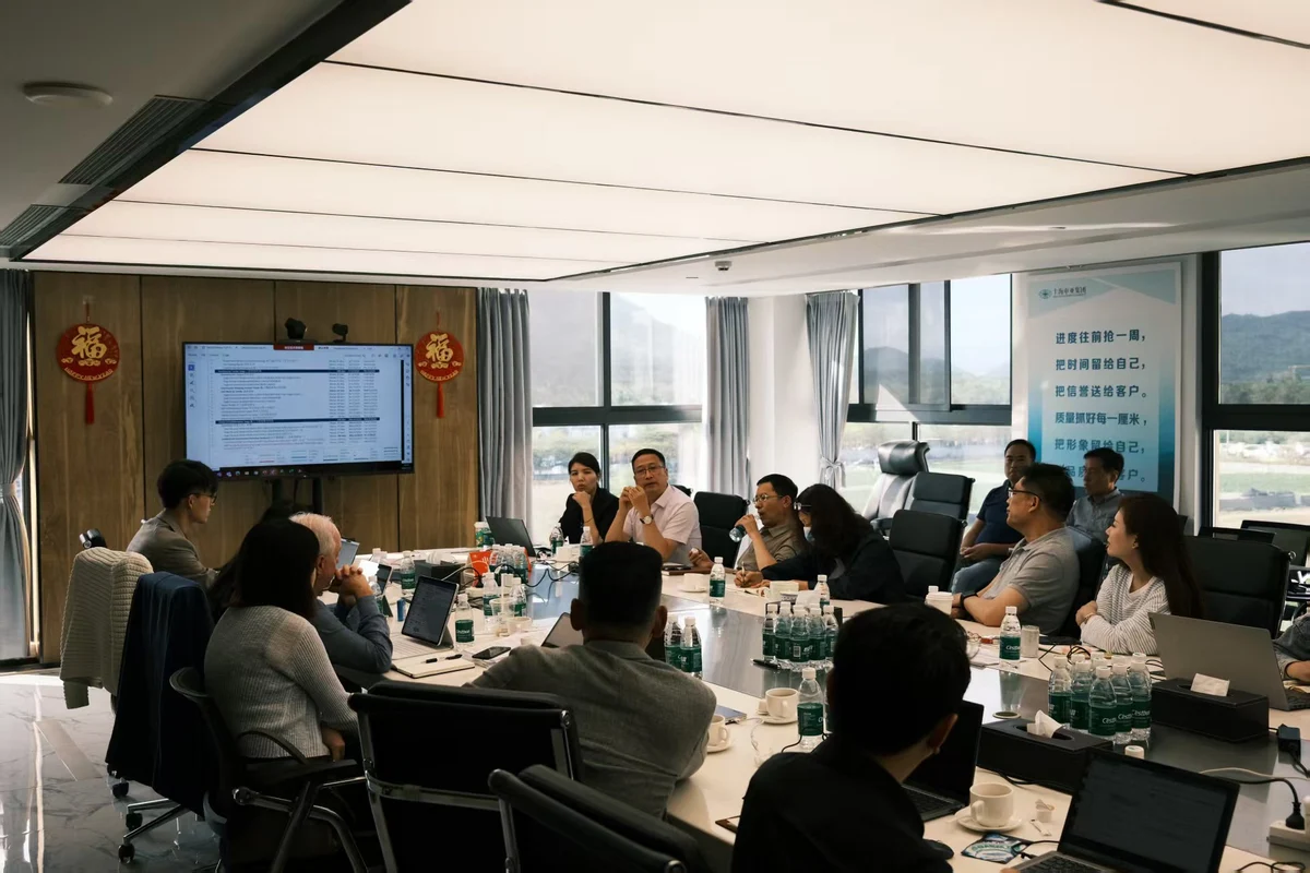Participants discussing project materials around a conference table